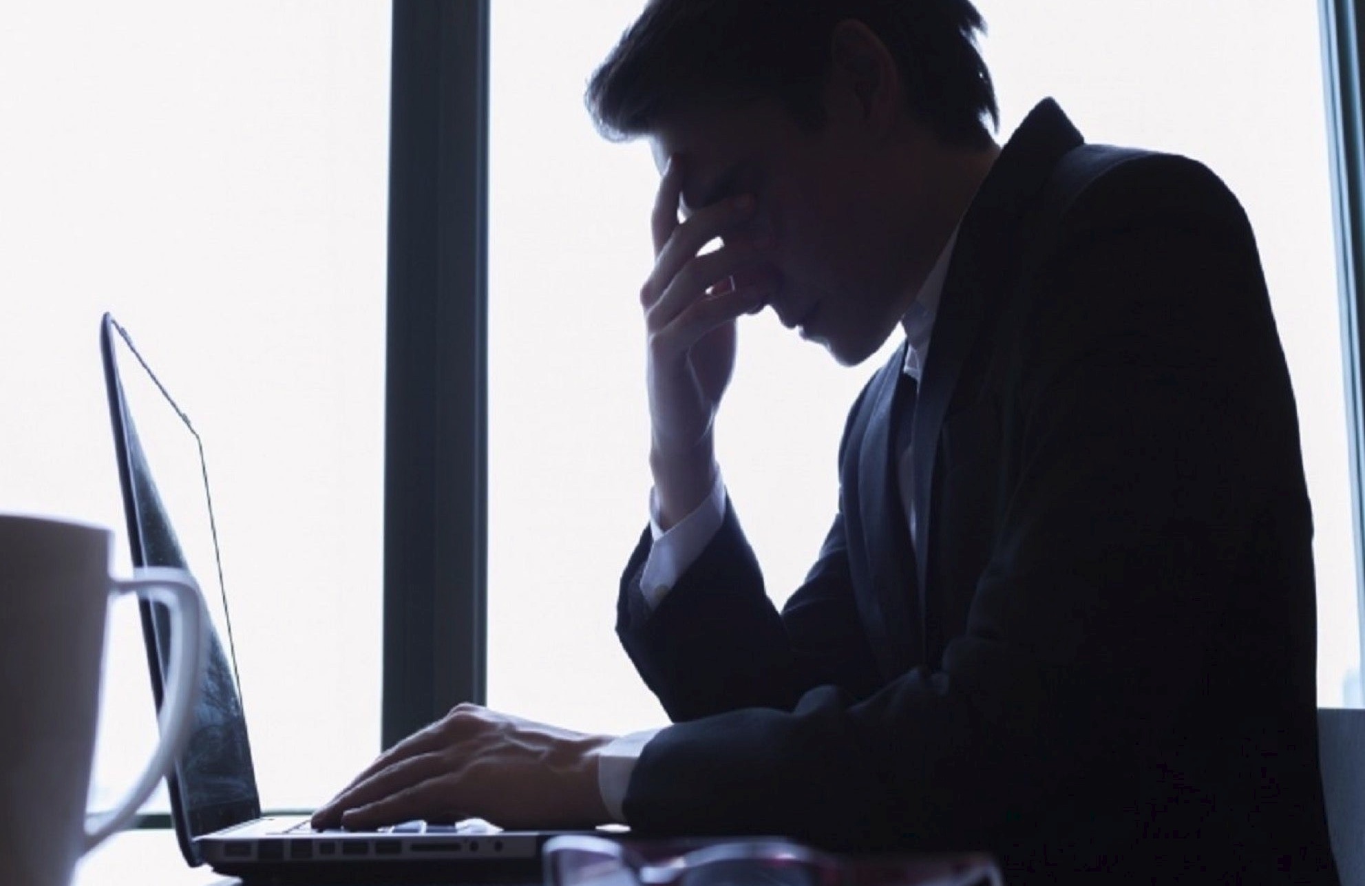 stressed out small business owner performing payroll functions